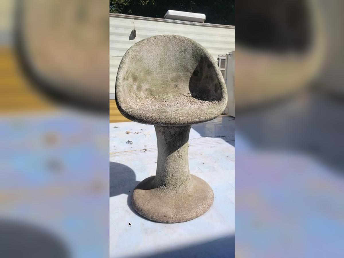 Sculptural concrete outdoor chair on a pedestal base
