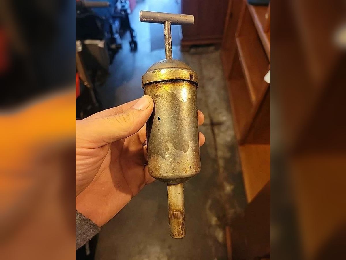 KP compact hand grease gun held in a hand